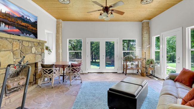 This space is located just off the second primary bedroom. It features large double pane windows and a fireplace. It is climated controled and can be used as a office or recreation room. | Image 34