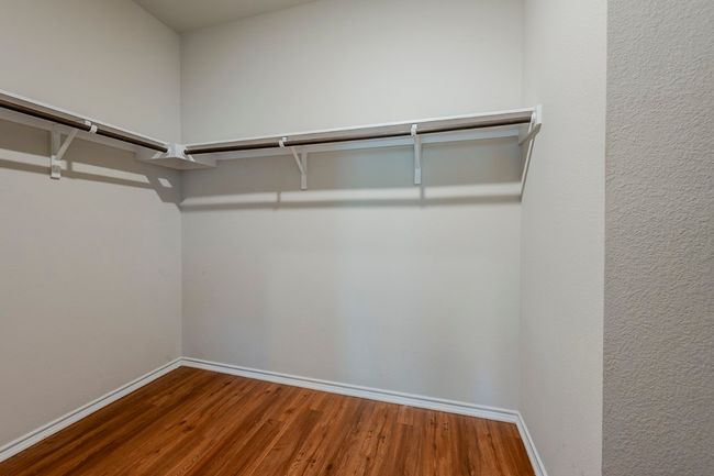 Walk in closet with wood finished floors | Image 18
