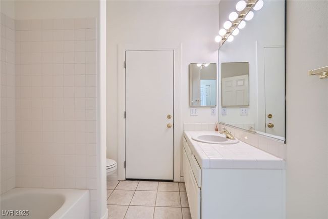 Bathroom with toilet, shower / tub combination, vanity, and tile patterned​​‌​​​​‌​​‌‌​‌‌​​​‌‌​​‌‌​‌​​​​​‌ floors | Image 35