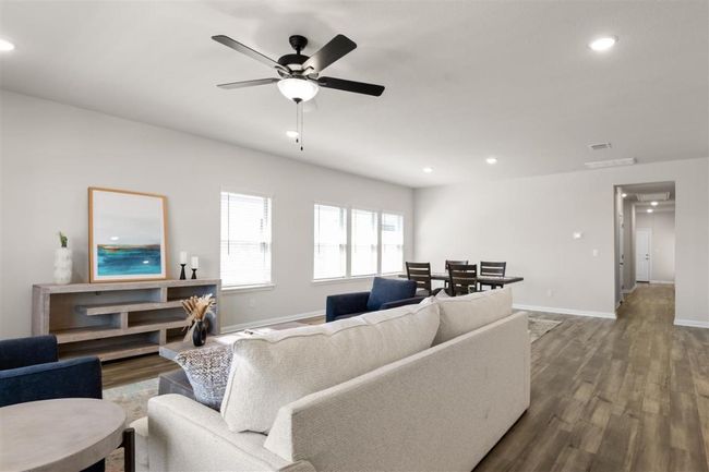 Living area with recessed lighting, baseboards, visible vents, ceiling fan, and wood finished floors | Image 9