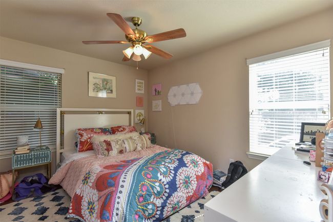 Bedroom featuring ceiling fan and multiple windows | Image 15