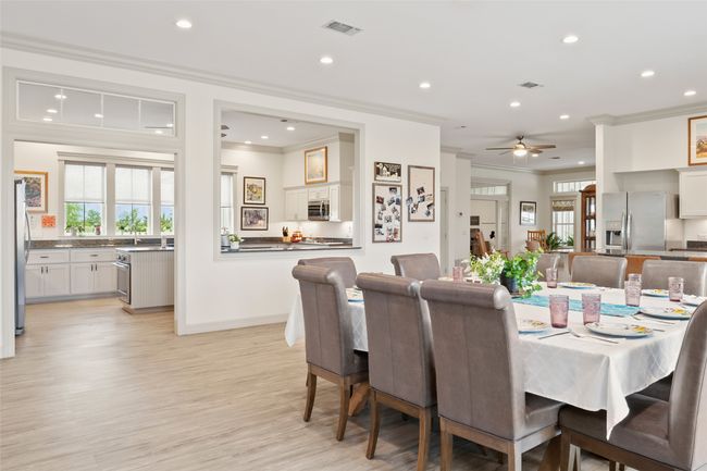 Dining area featuring ornamental molding, recessed lighting, visible vents, and light wood-style floors | Image 11
