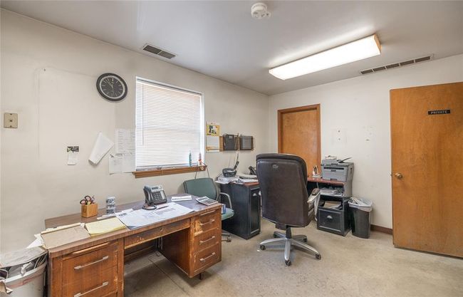Home office featuring light carpet | Image 17