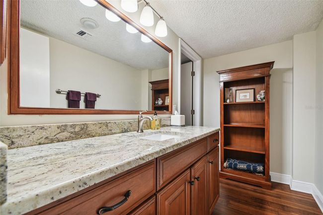 Master bathroom with granite countertop, cherry cabinets, and updated faucets. | Image 37