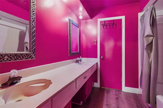 Bathroom with wood finished floors, double vanity, and a shower with shower curtain | Image 19
