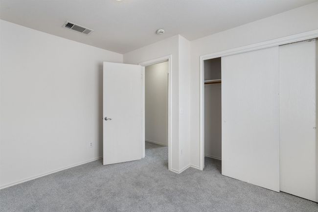 Unfurnished bedroom with carpet flooring and a closet | Image 24