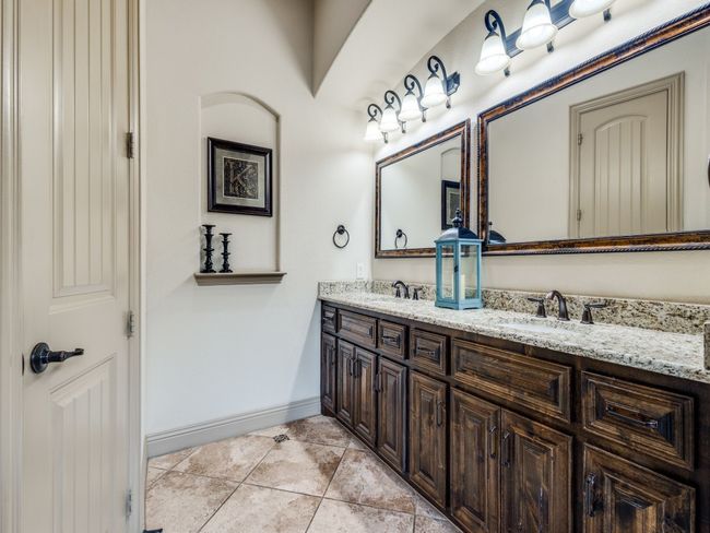 Bathroom featuring baseboards, double vanity, and tile patterned flooring | Image 15
