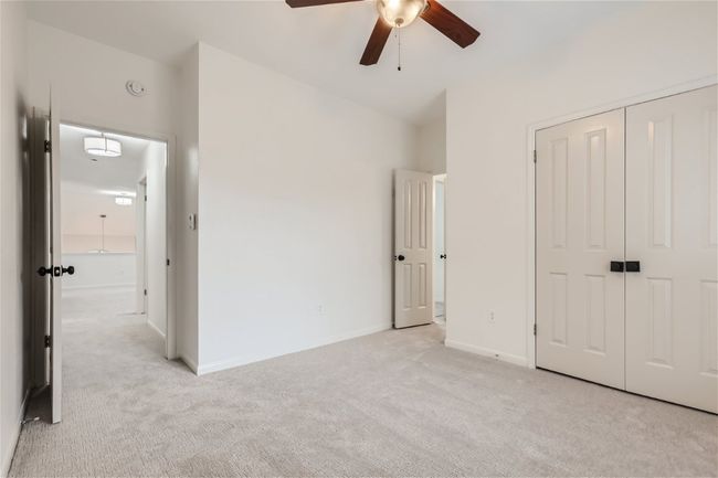 Unfurnished bedroom with light carpet, a closet, and baseboards | Image 30