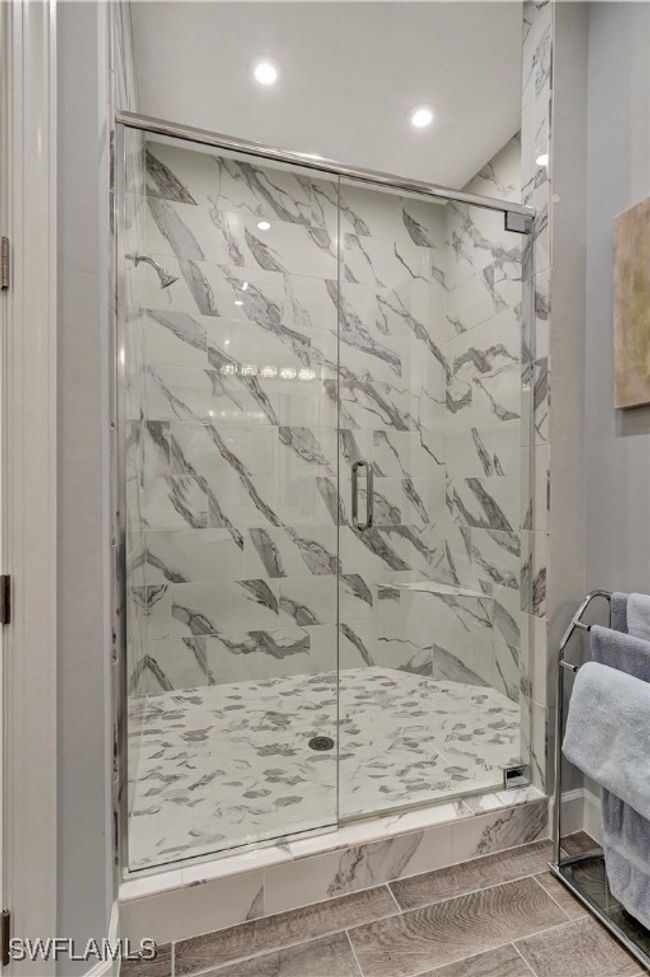 Featuring a frameless shower door and upgraded porcelain shower walls | Image 13