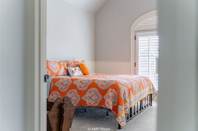 Carpeted bedroom with lofted ceiling | Image 26