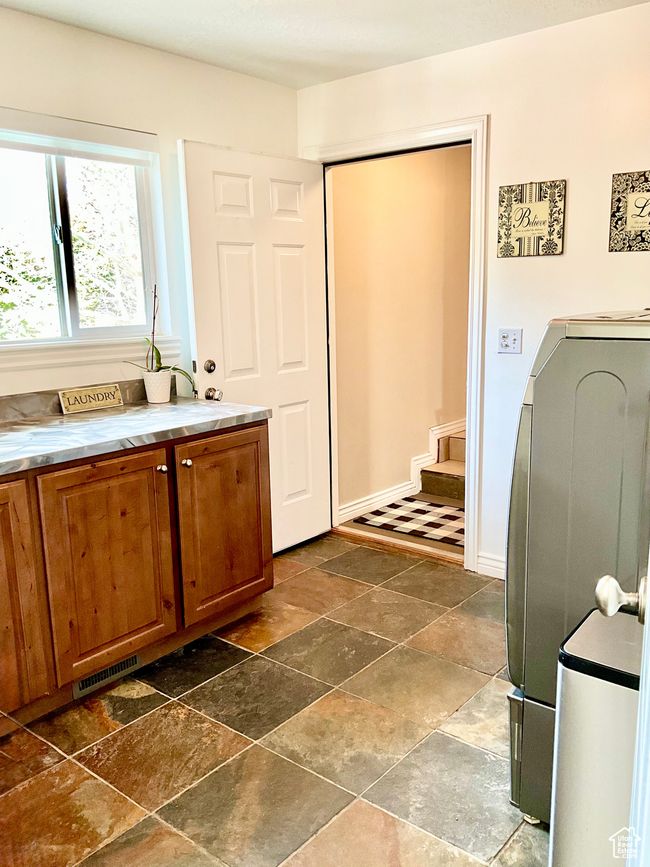 Laundry off kitchen leading to butler pantry/mudroom and garage. | Image 12