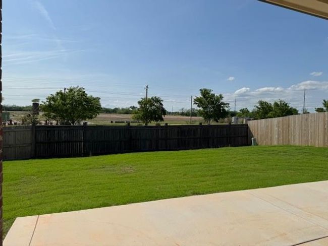 View of yard with a patio and fence | Image 39