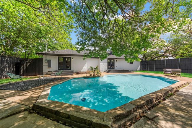 View of swimming pool featuring french doors, entry steps, a patio area, and a fenced backyard | Image 18