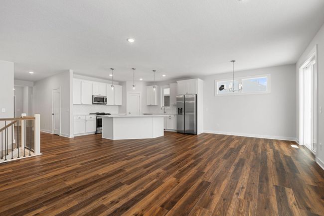 The open floor plan creates a seamless flow between the kitchen, dining, and living areas, allowing for easy interaction with family and guests while enhancing the sense of space and connectivity throughout. | Image 11