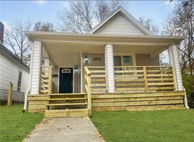 Bungalow with a front yard and a porch | Image 1