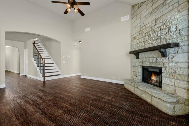 Offers a seamless transition from the inviting living room upstairs to a second living area. | Image 17