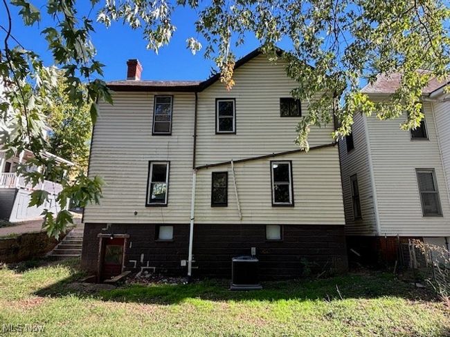 Rear view of property with central AC unit and a yard | Image 19