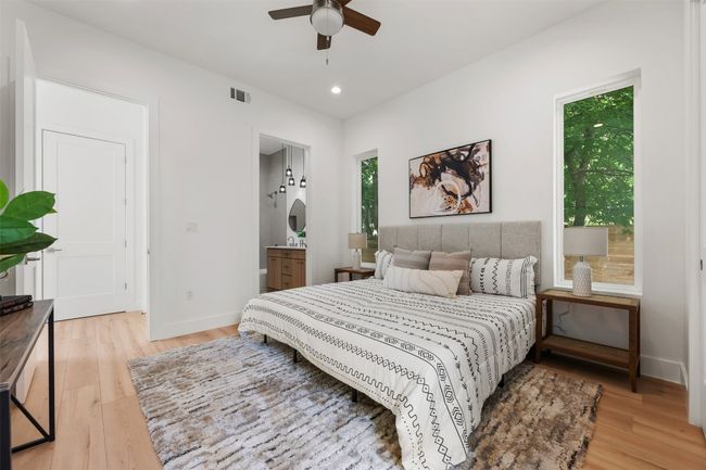 Bedroom with light wood-style floors, baseboards, recessed lighting, ensuite bathroom, and ceiling fan | Image 13