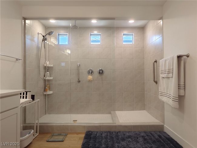 Full bathroom featuring tiled shower, a healthy amount of sunlight, and wood finished floors | Image 37