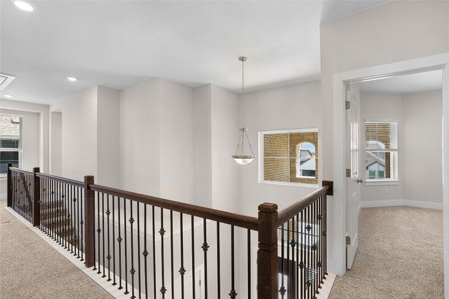 Hall featuring carpet, baseboards, recessed lighting, and an upstairs landing | Image 19