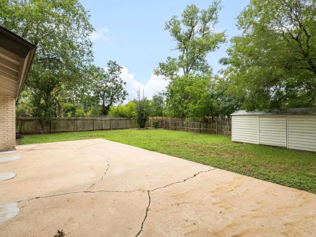 Fenced backyard with a patio and a shed | Image 22