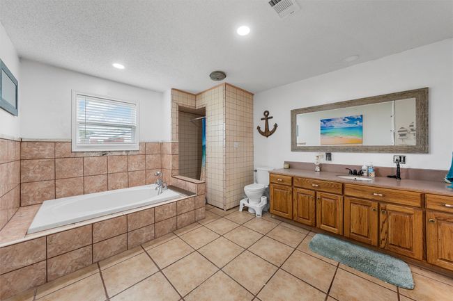 Full bathroom with a bath, vanity, a tile shower, tile patterned floors, and recessed lighting | Image 15