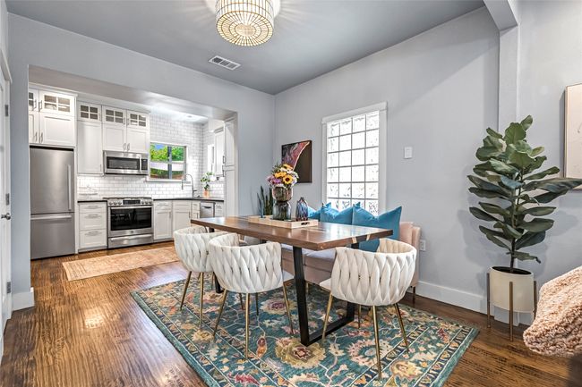 Dining area with healthy amount of natural light, dark wood-style floors, and baseboards | Image 6