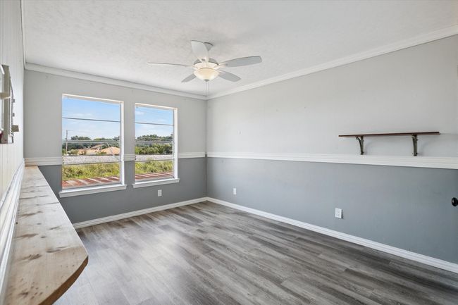 Spare room featuring ornamental molding, light wood finished floors, a ceiling fan, and a textured ceiling | Image 13