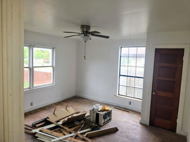 Empty room with baseboards, ceiling fan, a wealth of natural light, and wood finished floors | Image 13