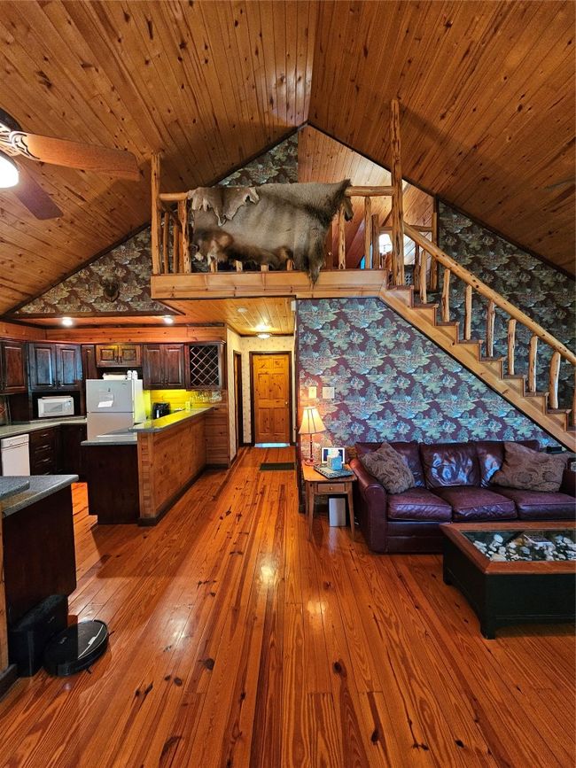 View from the Dining Area looking toward the Kitchen and Stairway. Note the Beauty and Symetry of the Wood Floors and Ceiling! | Image 13