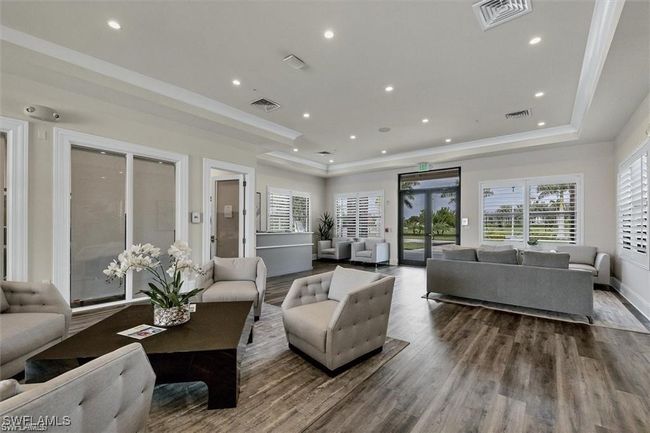 Living room featuring wood finished floors, a raised ceiling, recessed lighting, and ornamental molding | Image 22
