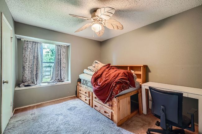 Carpeted bedroom with a textured ceiling and a ceiling fan | Image 20