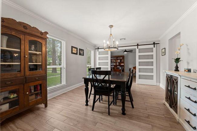 Bright dining area with large windows, allow for ample natural light. This space flows effortlessly into the home office space. | Image 15