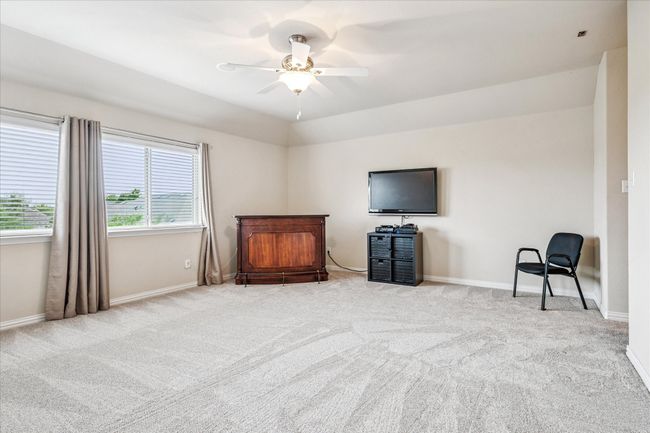 Unfurnished bedroom featuring carpet flooring, baseboards, and ceiling fan | Image 22