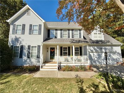 View of front of home featuring covered porch and a front yard | Image 1