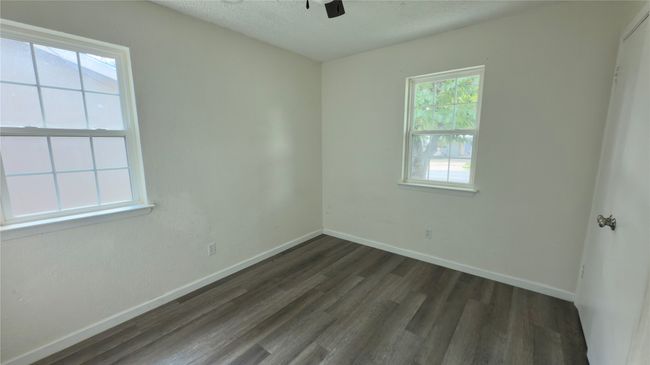 Spare room featuring dark wood-style floors, a textured ceiling, and ceiling fan | Image 31