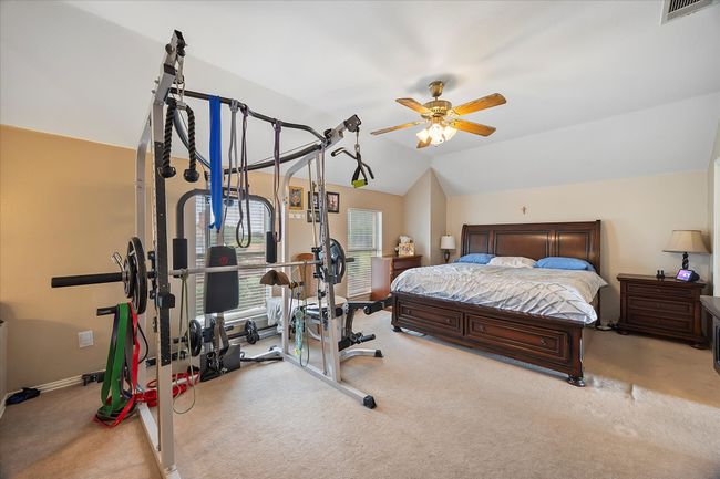 Bedroom with carpet flooring, lofted ceiling, baseboards, and a ceiling fan | Image 26