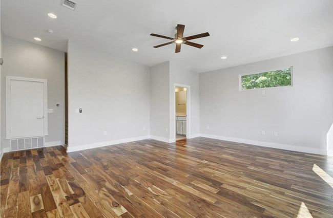 Empty room with visible vents, baseboards, ceiling fan, and wood finished floors | Image 28