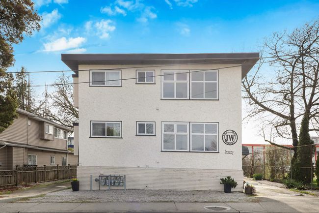 Rear view of house featuring stucco siding and fence | Image 28