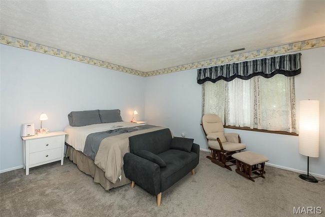 Bedroom featuring carpet, baseboards, and a textured ceiling | Image 27