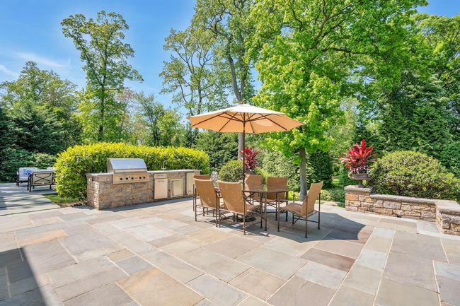 Full service outdoor kitchen w. Viking gas BBQ, stone countertop and Viking refrigerator | Image 22