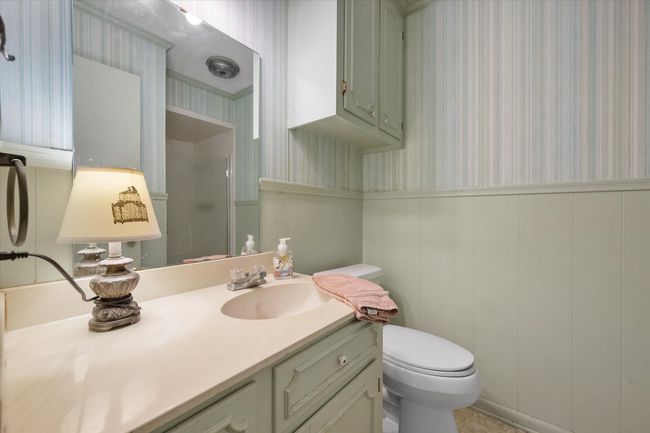 Full bath featuring wallpapered walls with an enclosed shower off of utility room and by 4th bedroom. | Image 31