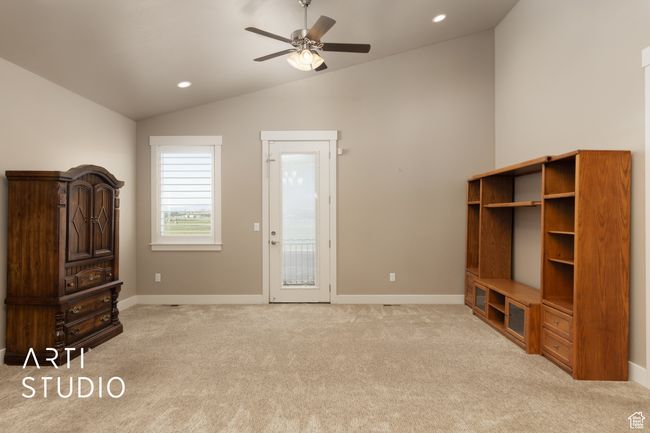 Unfurnished living room featuring lofted ceiling, a ceiling fan, light colored carpet, and recessed lighting | Image 20
