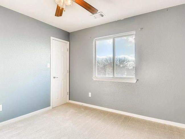 Empty room with light carpet, ceiling fan, and baseboards | Image 20