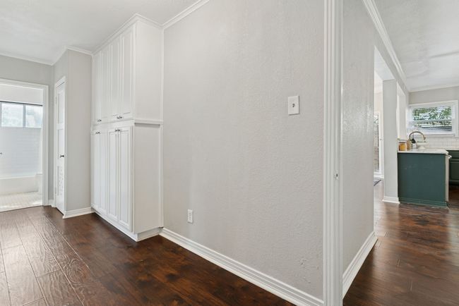 Hallway leading to bedrooms with extra storage. | Image 22