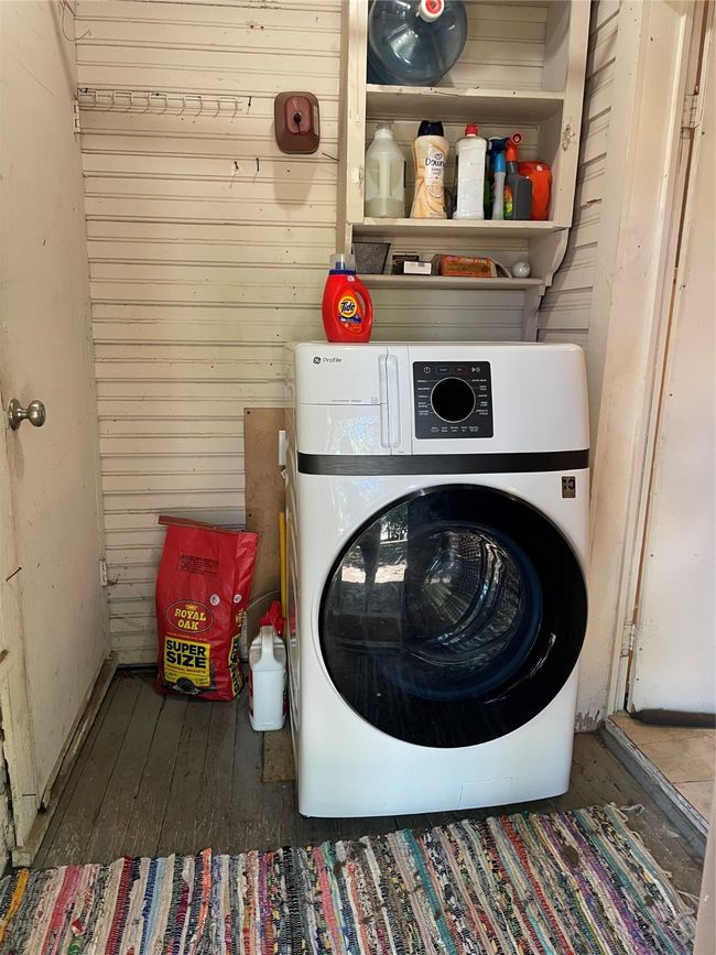 Laundry room featuring wood walls, washer / clothes dryer, and hardwood / wood-style floors | Image 15