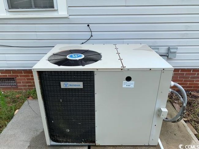 Exterior view of central air condition unit and crawl space | Image 23