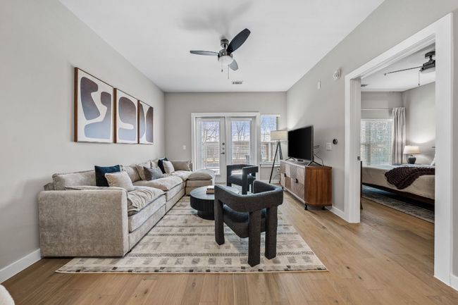 Living room featuring visible vents, a ceiling fan, baseboards, and light wood finished floors | Image 13