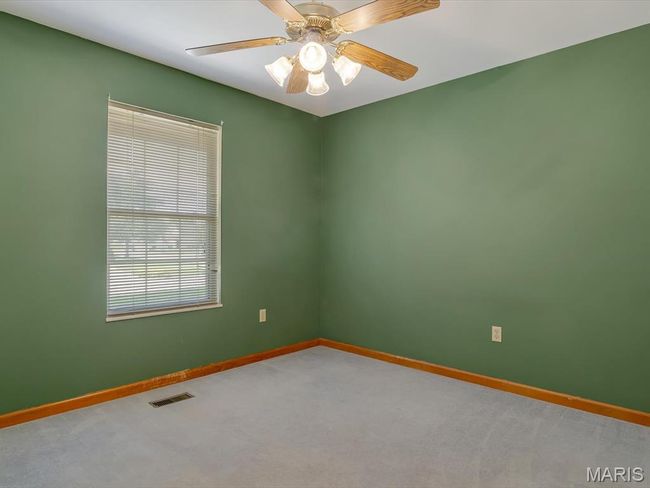Bedroom featuring light carpet and a ceiling fan | Image 17