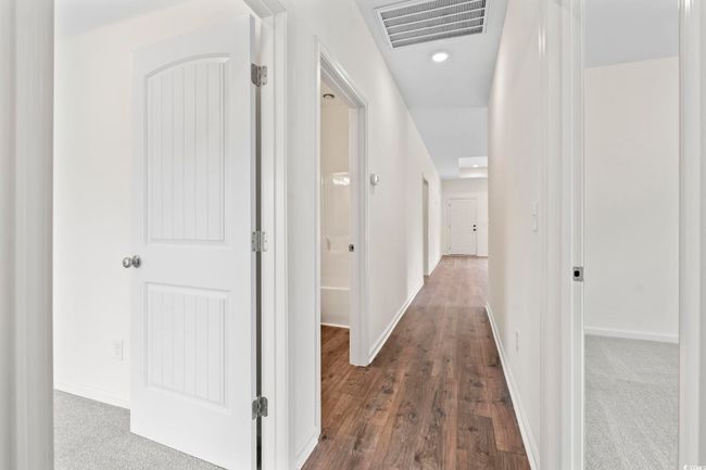 Hallway featuring dark wood-type flooring, recessed lighting, and baseboards | Image 15